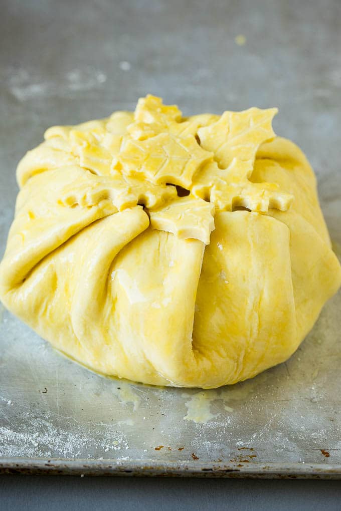 Baked Brie Recipe | Pastry Wrapped Brie #brie #cheese #appetizer #pecans #raspberries #edsug Cheese wrapped in puff pastry and topped with egg wash.