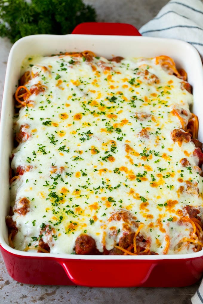 Baked Spaghetti Recipe | Baked Pasta #spaghetti #pasta #cheese #casserole #beef #sausage #dinner #edsug Spaghetti in a baking dish with melted cheese baked on top.