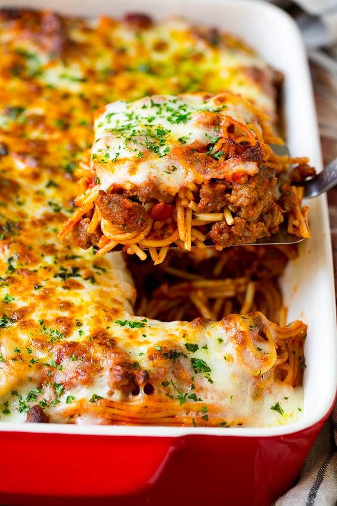 Baked Spaghetti Recipe | Baked Pasta #spaghetti #pasta #cheese #casserole #beef #sausage #dinner #edsug A spatula holding up a serving of baked spaghetti.
