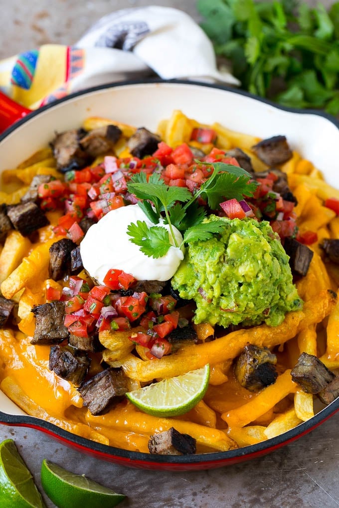 Carne Asada Fries Recipe | Steak Fries #fries #frenchfries #steak #salsa #avocado #cheese #dinner #appetizer #edsug Carne asada fries topped with melted cheese, steak, salsa and guacamole.