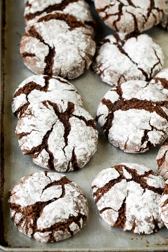 Chocolate Crinkle Cookies Recipe #cookies #chocolate #christmas #dessert #baking #edsug Crinkle cookies on a sheet pan.