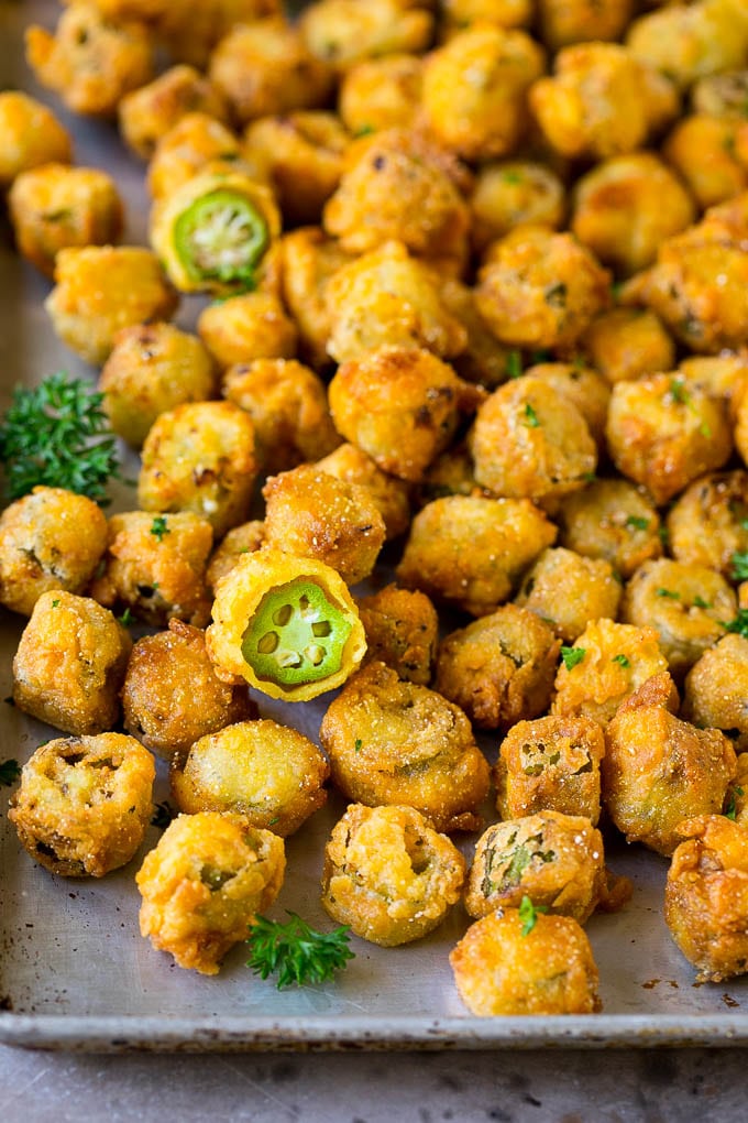 Fried Okra Recipe #okra #appetizer #sidedish #edsug Fried okra on a sheet pan, garnished with chopped parsley.