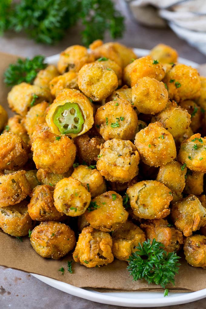 Fried Okra Recipe #okra #appetizer #sidedish #edsug A serving plate of fried okra garnished with parsley.