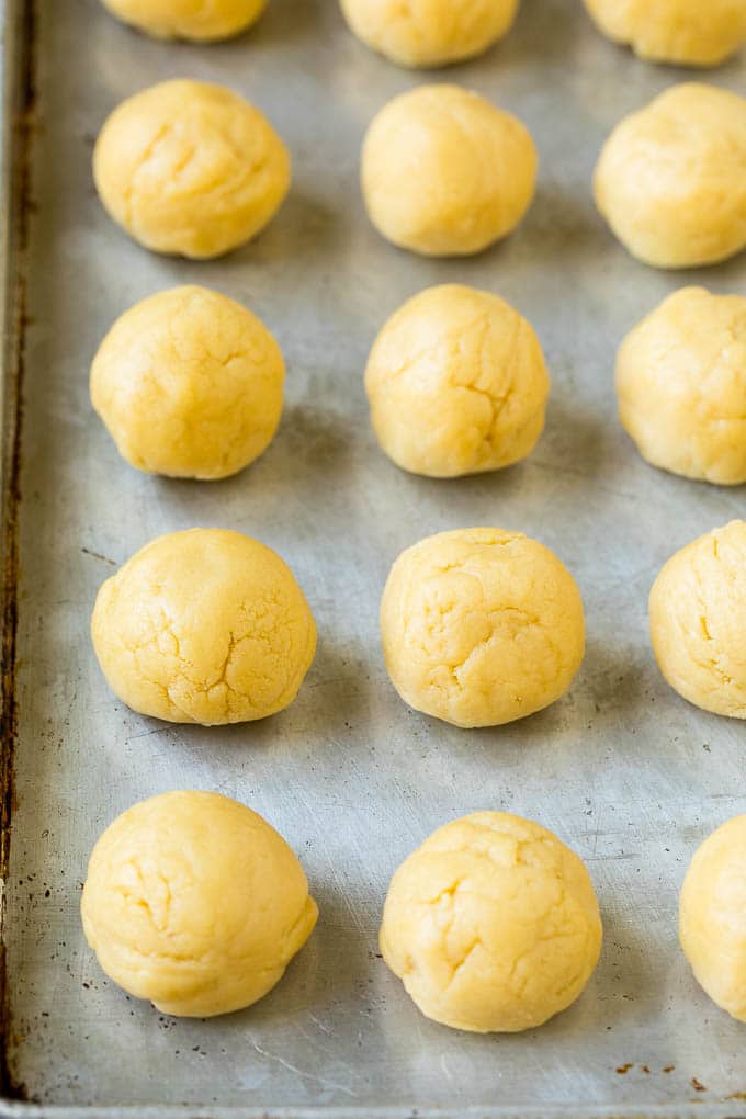 Italian Cookies Recipe | Almond Cookies #cookies #italianfood #frosting #sprinkles #baking #christmas #edsug Balls of cookie dough on a sheet pan.