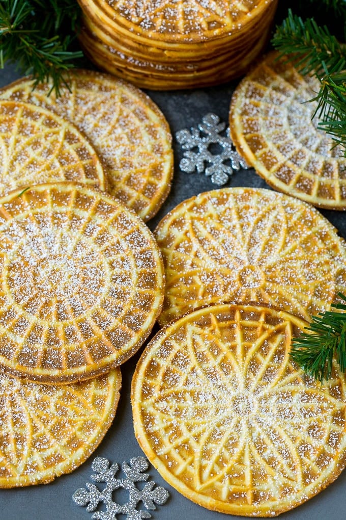 Pizzelle Cookies Recipe #cookies #baking #dessert #christmas #edsug Pizzelle cookies cooked to golden brown and coated in powdered sugar.