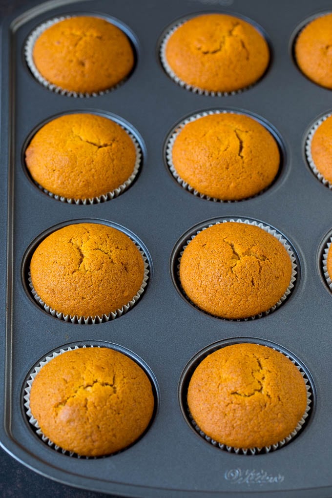 Pumpkin Cupcakes Recipe | Pumpkin Cake #cake #cupcakes #pumpkin #frosting #baking #fall #thanksgiving #edsug Baked cupcakes in a muffin tin.