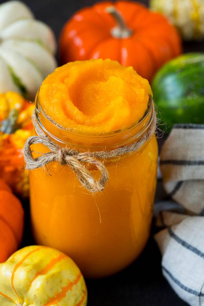 Pumpkin Puree Recipe #pumpkin #baking #fall #thanksgiving #edsug A jar of pumpkin puree surrounded by fall produce.