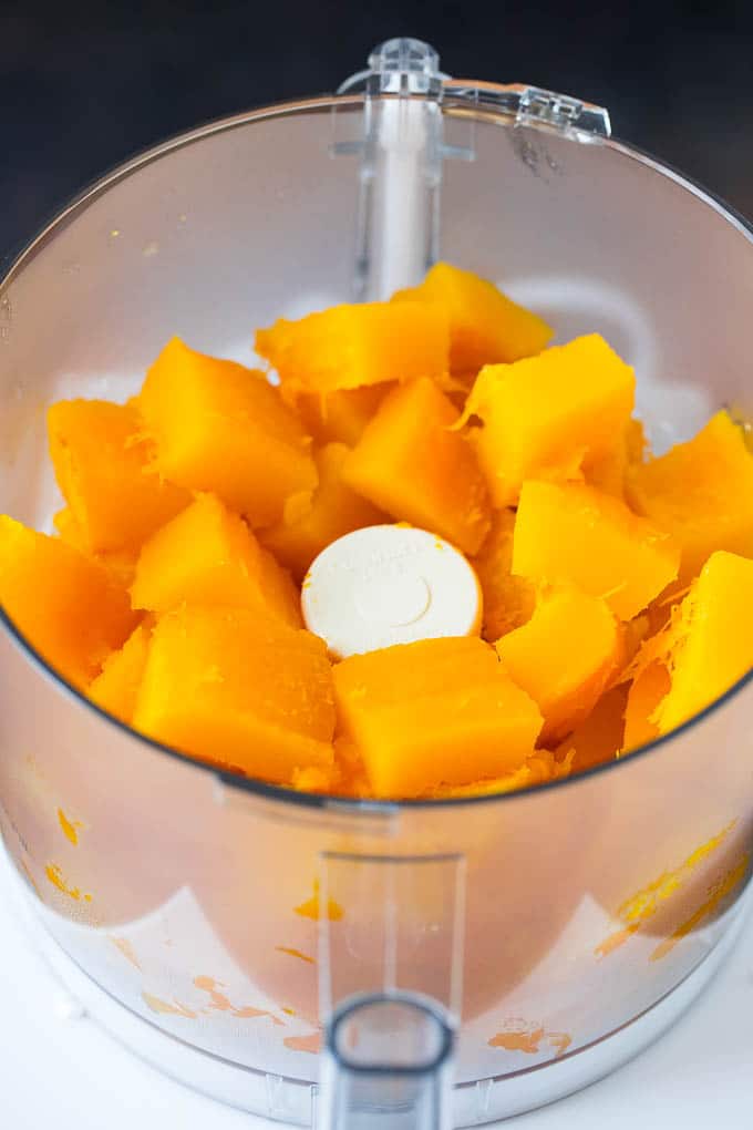 Pumpkin Puree Recipe #pumpkin #baking #fall #thanksgiving #edsug Cubes of pumpkin in a food processor.