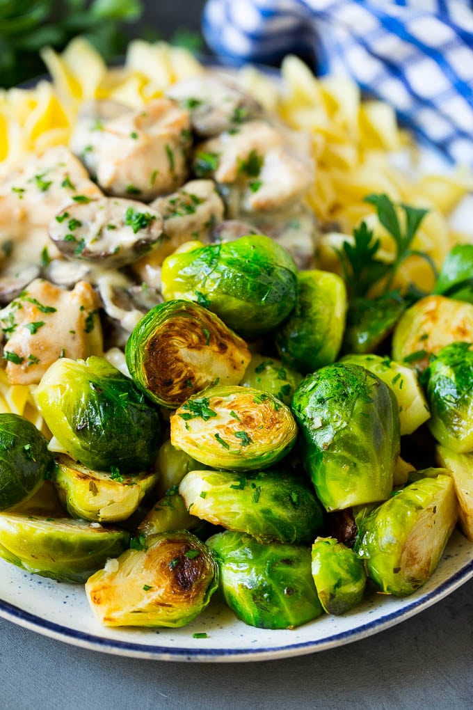 Sauteed Brussels Sprouts Recipe | Brussels Sprouts Side Dish #brusselssprouts #sprouts #veggies #sidedish #garlic #vegetarian #dinner #edsug Sauteed brussels sprouts served alongside chicken and noodles.