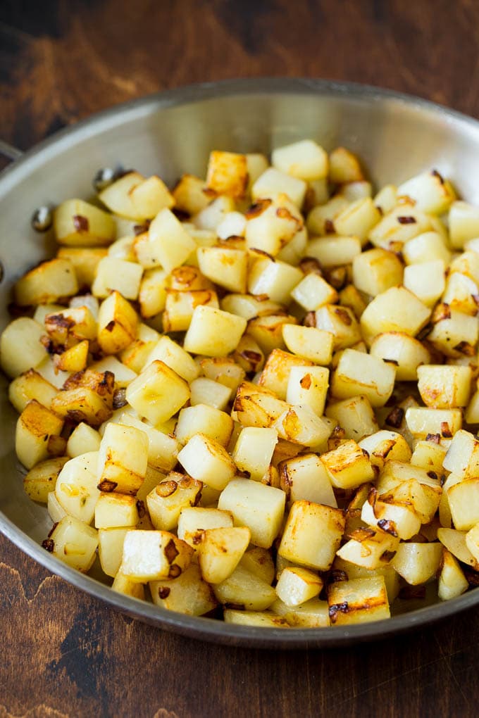 Corned Beef Hash Recipe #hash #cornedbeef #stpatricksday #breakfast #brunch #potatoes #edsug Sauteed potatoes in a skillet.