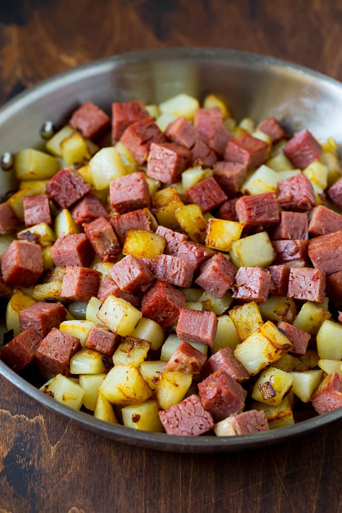 Corned Beef Hash Recipe #hash #cornedbeef #stpatricksday #breakfast #brunch #potatoes #edsug Corned beef and potatoes cooked together in a pan.