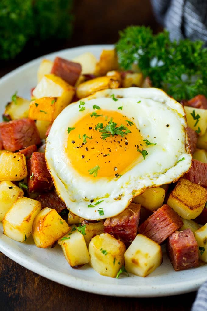 Corned Beef Hash Recipe #hash #cornedbeef #stpatricksday #breakfast #brunch #potatoes #edsug A plate of corned beef hash topped with a fried egg.