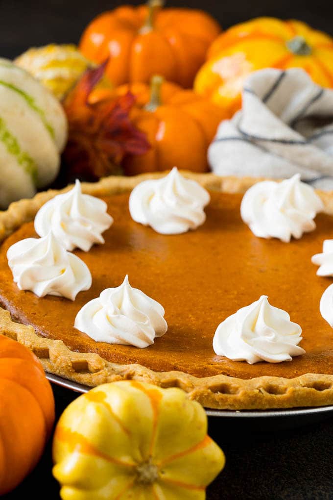 Homemade Pumpkin Pie Recipe | Pumpkin Pie #pie #pumpkin #baking #thanksgiving #fall #dessert #edsug Homemade pumpin pie topped with rosettes of whipped cream.