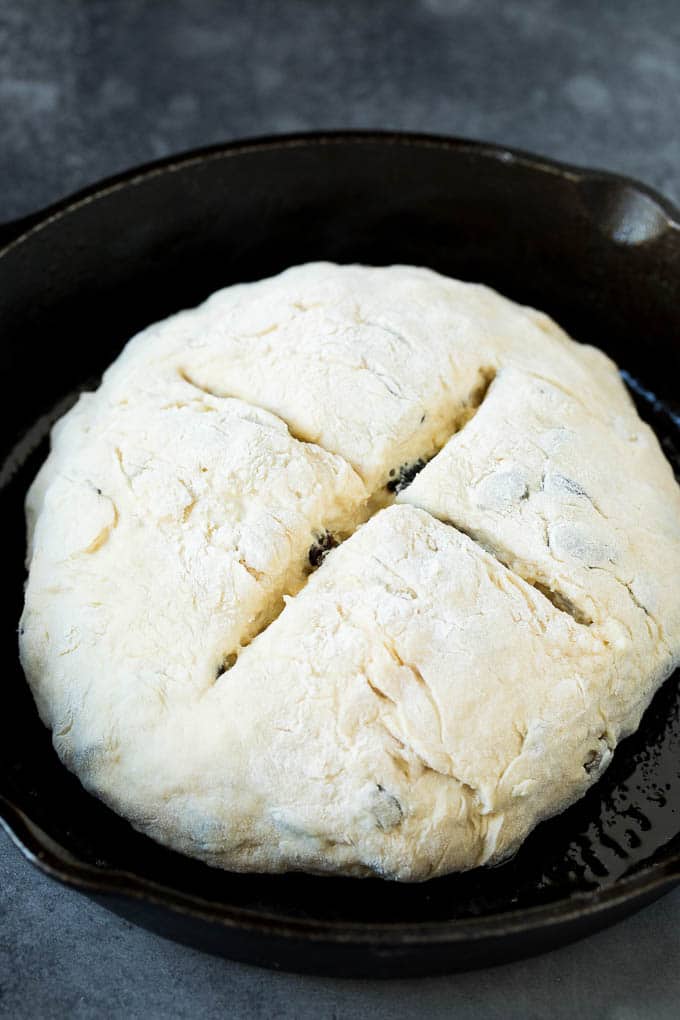 Irish Soda Bread Recipe #bread #baking #stpatricksday #sidedish #edsug A shaped loaf of soda bread in a skillet.