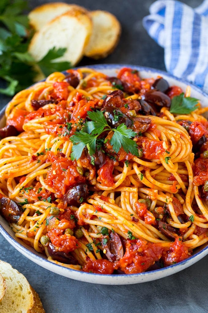 Pasta Puttanesca Recipe #pasta #tomatoes #olives #italianfood #dinner #edsug Pasta puttanesca with spaghetti tossed in a homemade tomato sauce.