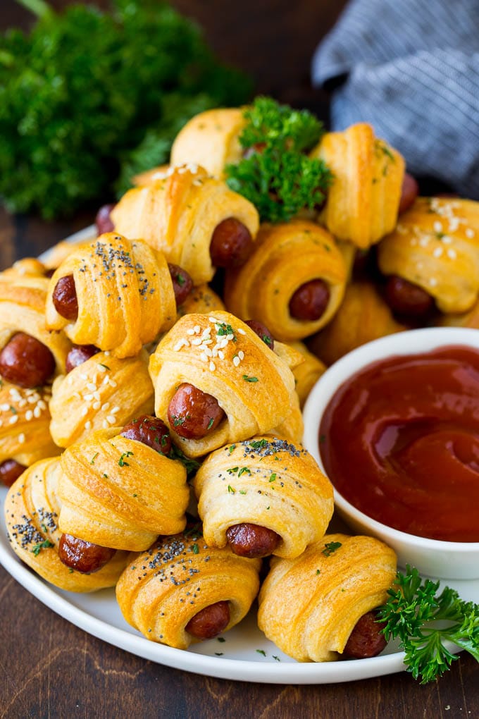 Pigs in a Blanket Recipe #hotdogs #appetizer #snack #comfortfood #edsug A plate of pigs in a blanket served with ketchup.
