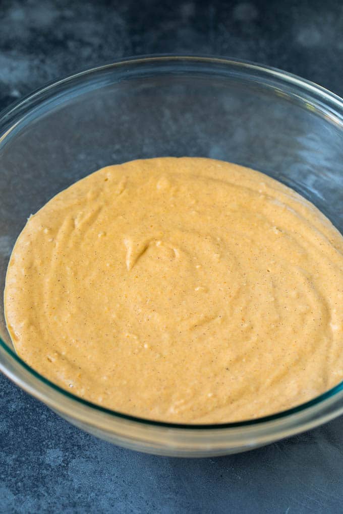 These pumpkin pancakes are light and fluffy buttermilk hotcakes flavored with pumpkin puree and spices. Pancake batter in a mixing bowl.