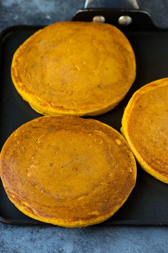 These pumpkin pancakes are light and fluffy buttermilk hotcakes flavored with pumpkin puree and spices. Hotcakes on a griddle.
