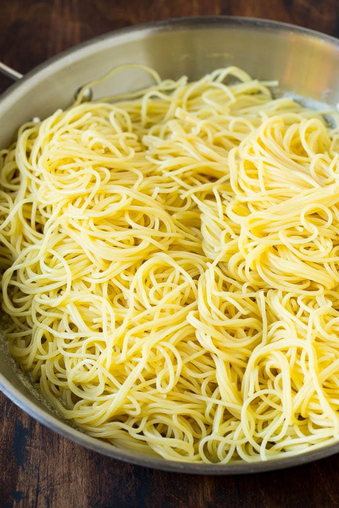 Garlic and Herb Angel Hair Pasta #pasta #garlic #sidedish #dinner #edsug Pasta in a pan with garlic and butter.