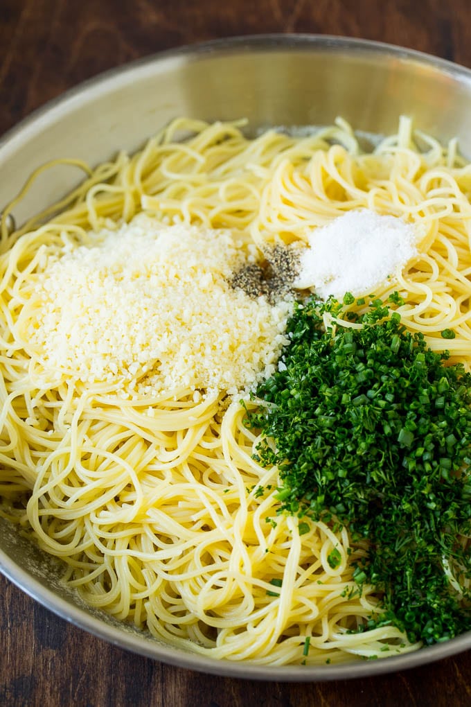 Garlic and Herb Angel Hair Pasta #pasta #garlic #sidedish #dinner #edsug Pasta topped with herbs, cheese, salt and pepper.