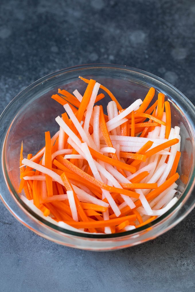Bahn Mi Sandwich Recipe #sandwich #pork #lunch #dinner #edsug Shredded carrots and daikon radish in a bowl.
