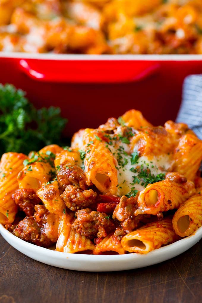 Baked Rigatoni Pasta #pasta #dinner #italianfood #groundbeef #edsug #casserole A plate of baked rigatoni topped with melted cheese.