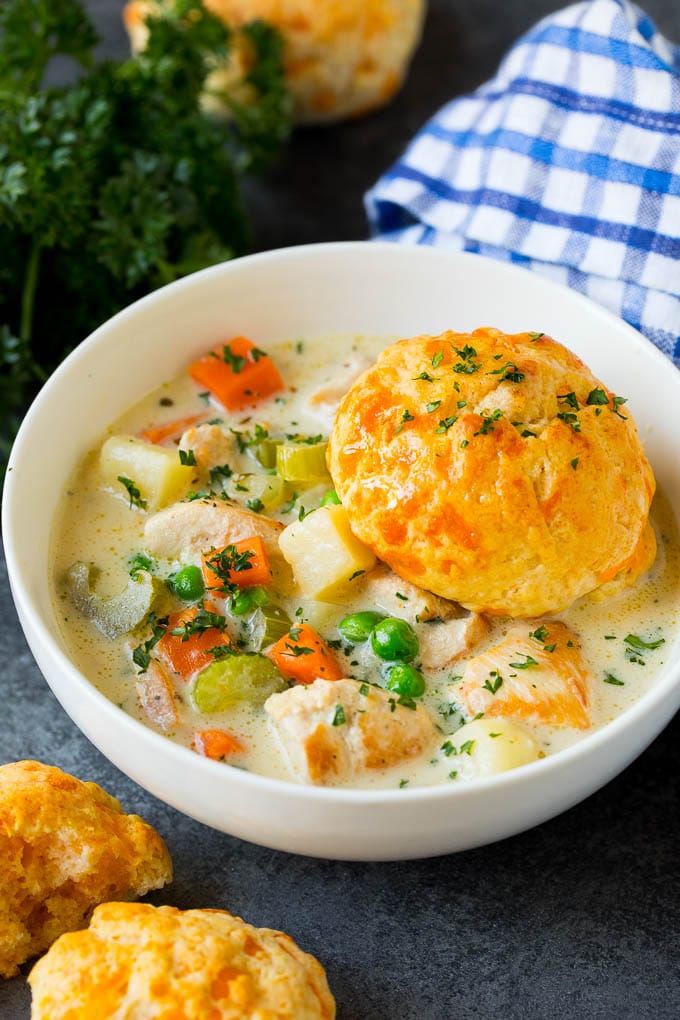 Chicken Pot Pie Soup Recipe | Chicken Soup #soup #chicken #dinner #comfortfood #edsug A bowl of chicken pot pie soup with a biscuit on top.
