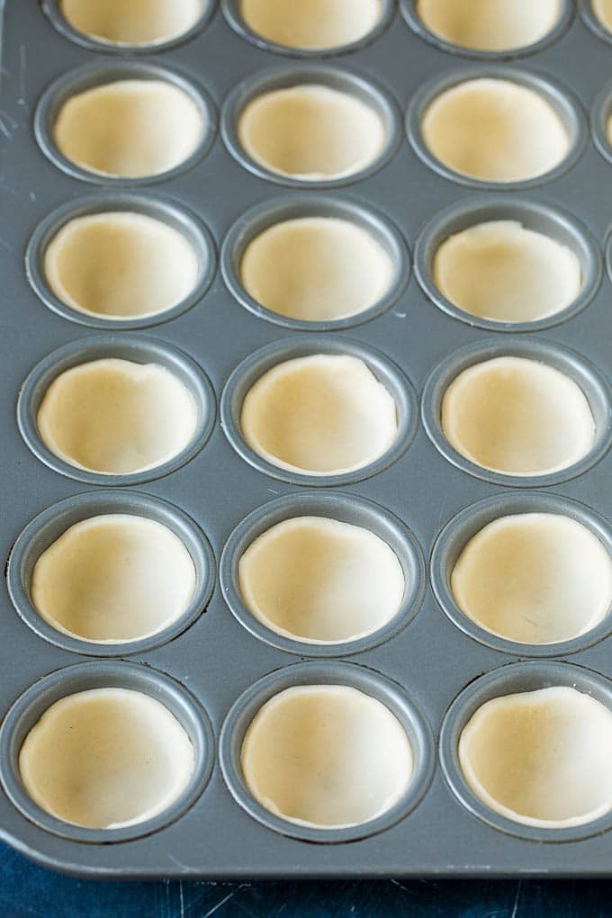 Mini Quiche Recipe #eggs #breakfast #brunch #appetizer #edsug Pie crust rounds pressed into muffin tins.
