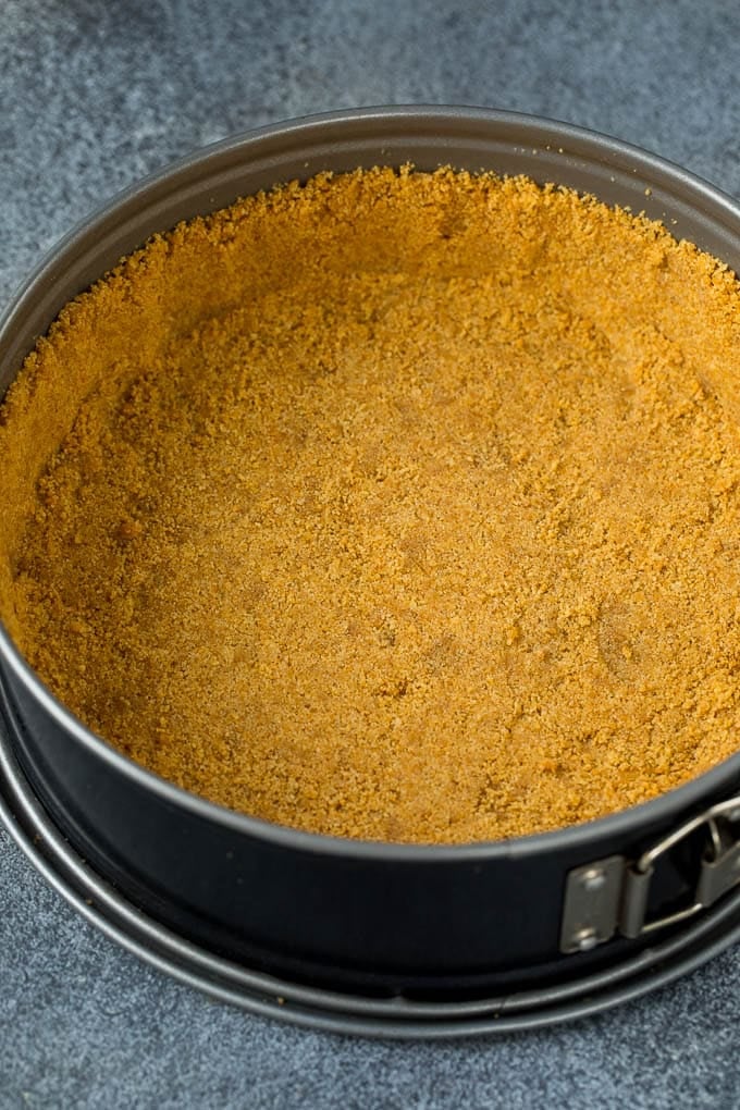 Pecan Pie Cheesecake | Pecan Cheesecake #cake #cheesecake #dessert #edsug #thanksgiving Graham cracker crust in a springform pan.