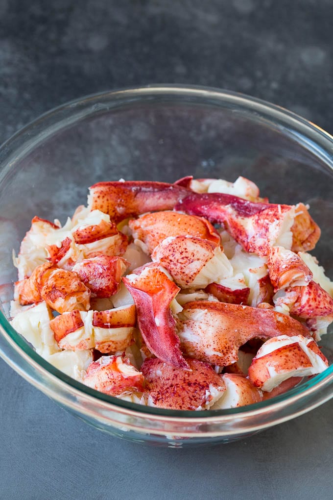 Lobster rolls stuffed with creamy lobster salad in a toasted bun. #lobster #edsug Chunks of lobster meat in a bowl.