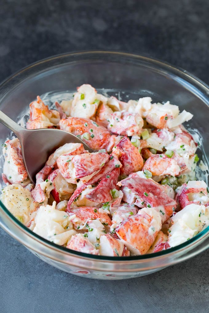 Lobster rolls stuffed with creamy lobster salad in a toasted bun. #lobster #edsug Lobster salad in a bowl in a creamy dressing.