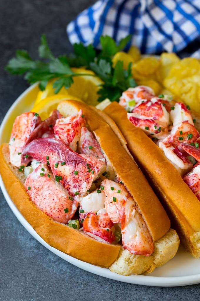 Lobster rolls stuffed with creamy lobster salad in a toasted bun. #lobster #edsug Lobster roll with chunks of fresh lobster meat in a buttered and toasted bun.