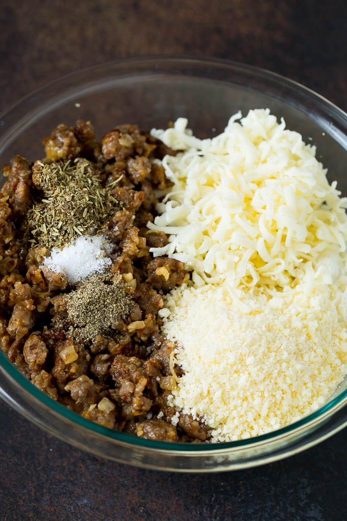Baked Manicotti Recipe #pasta #cheese #dinner #edsug Sausage, cheeses and herbs in a mixing bowl.