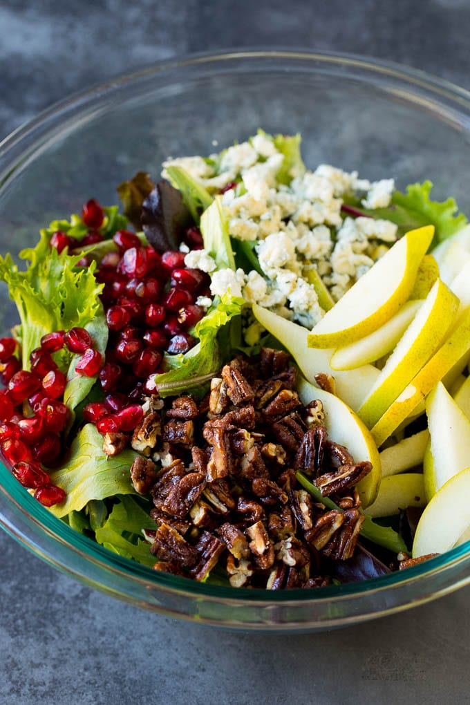 Pear Salad Recipe #salad #pears #fall #winter #dinner #edsug Lettuce with sliced pears, blue cheese and pecans on top.