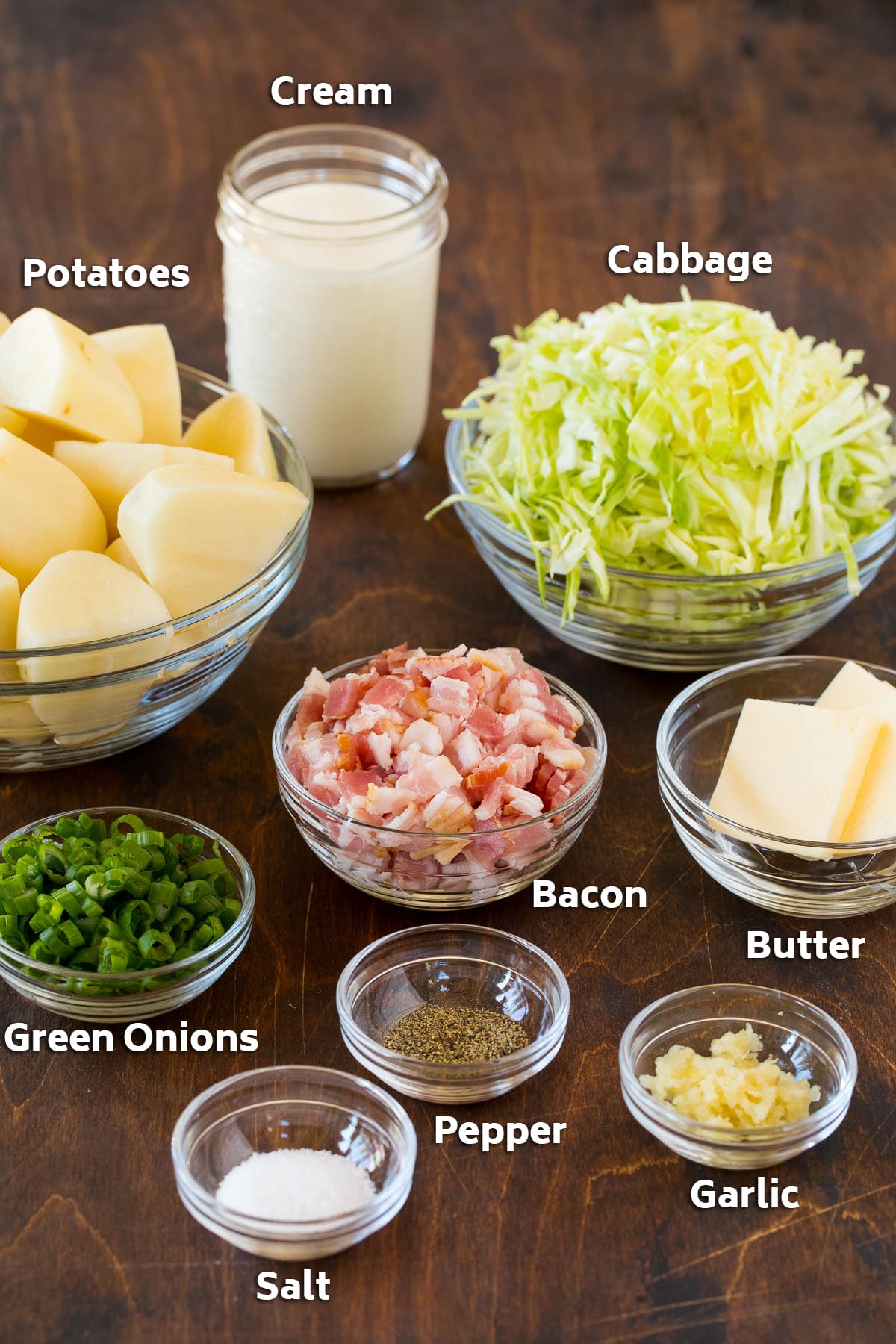 Colcannon Recipe | Mashed Potatoes #potatoes #cabbage #bacon #sidedish #stpatricksday #dinner #edsug Bowls of bacon, cabbage, potatoes, and seasonings.