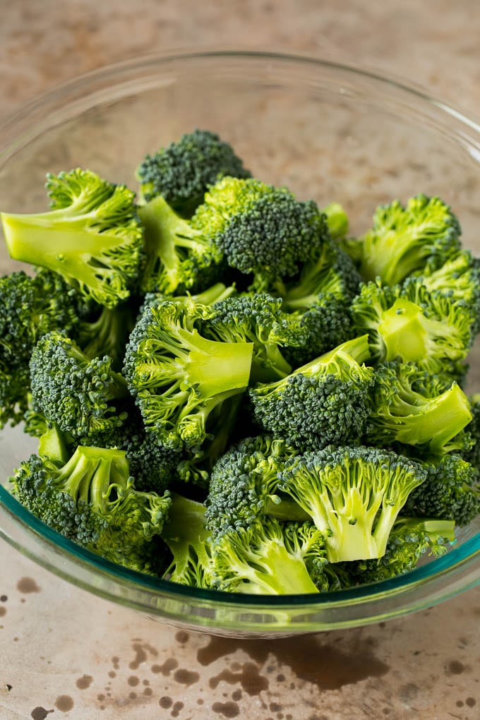 Grilled broccoli is packed with flavor and is a colorful and healthy side dish! #broccoli #edsug Green florets in a bowl.