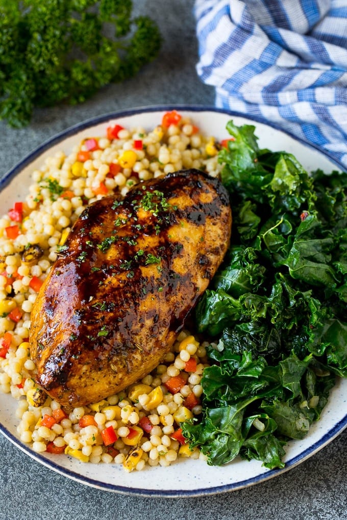 Sauteed kale flavored with olive oil and garlic, a quick and easy side dish! #kale #edsug Grilled chicken served with a side of sauteed kale.