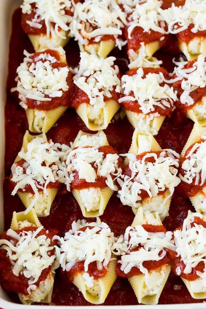 Baked stuffed shells filled with three types of cheese and topped with marinara sauce. #pasta #edsug Filled pasta topped with marinara sauce and shredded cheese.