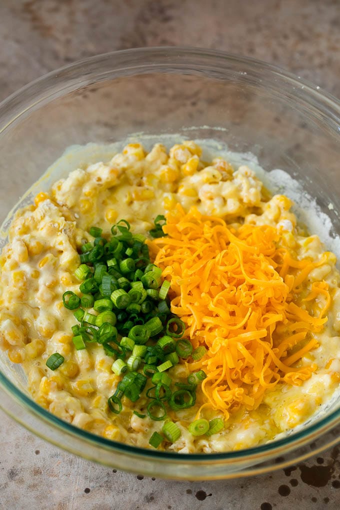 These crispy corn fritters are easy to make and are the perfect appetizer or lighter main course. #corn #edsug Corn batter topped with green onions and shredded cheese.