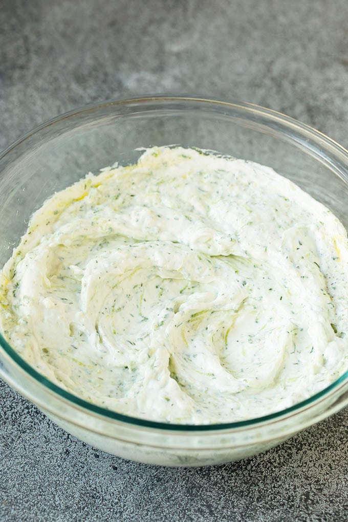 The best homemade tzatziki sauce with cucumber and herbs mixed into Greek yogurt. #appetizer #edsug Tzatziki sauce in a glass bowl.
