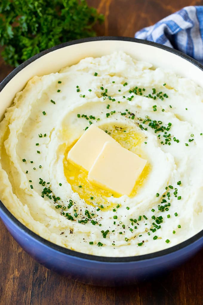 These cream cheese mashed potatoes are boiled potatoes blended with butter, milk, cream cheese and seasonings to make a rich and creamy side dish. A pot of cream cheese mashed potatoes topped with butter and chives.