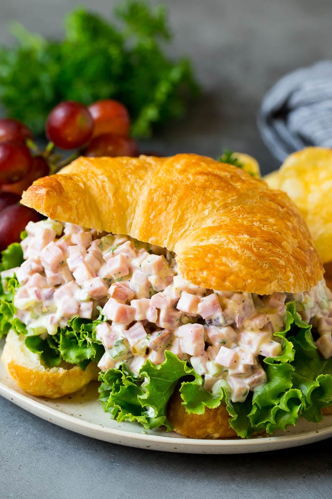 This ham salad is a blend of finely diced ham, mayonnaise, veggies and seasonings, all mixed together to form a savory and creamy salad. Ham salad served in a croissant.