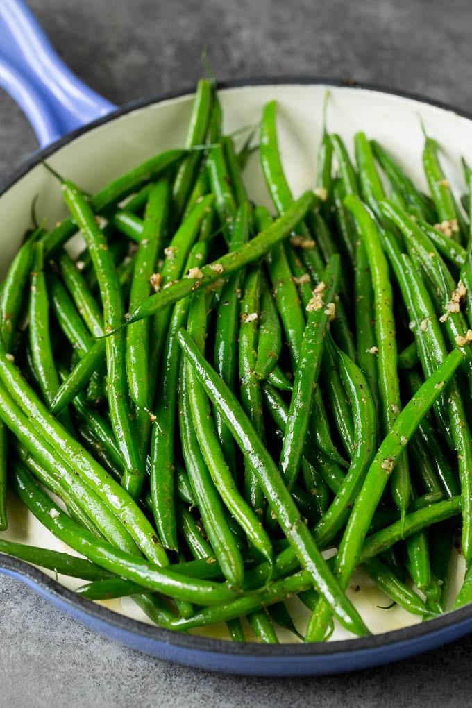 These sauteed green beans are cooked in butter, garlic and an assortment of fresh and dried herbs. Cooked beans tossed with garlic and herbs.