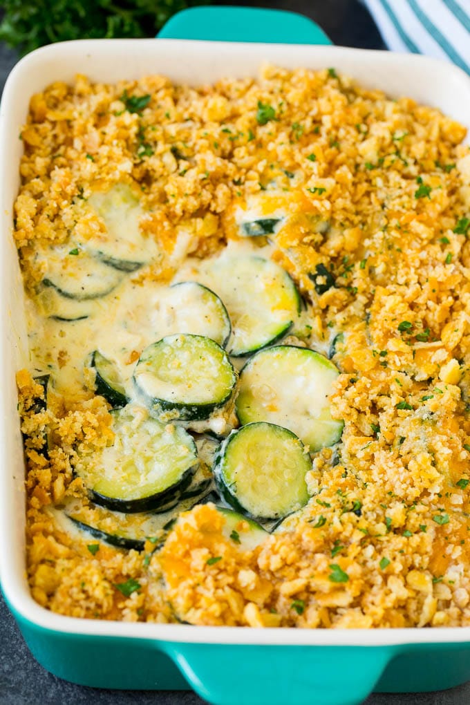 This zucchini casserole is sauteed squash tossed in a creamy sauce with plenty of cheese, all topped off with cracker crumbs and baked to perfection. Zucchini casserole with sliced squash in a creamy sauce, topped with melted cheese and cracker crumbs.
