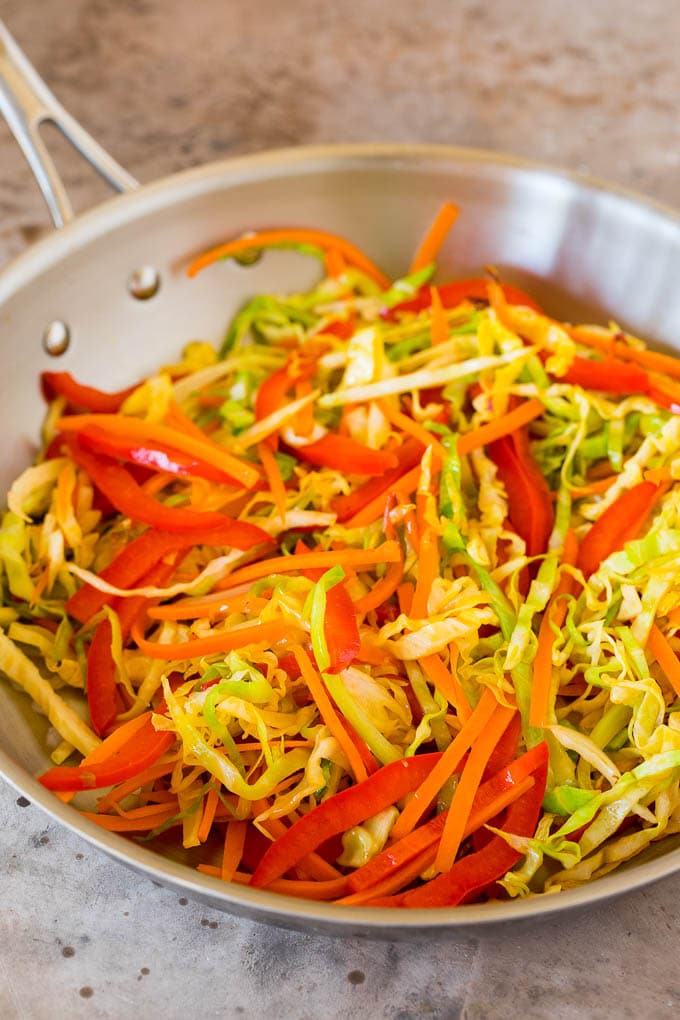 These yakisoba noodles are tender noodles stir fried with chicken and assorted vegetables in a savory sauce. Stir fried vegetables in a skillet.