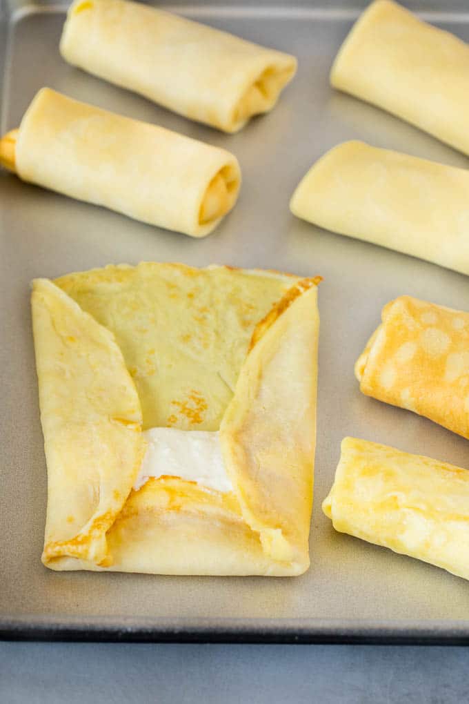 A crepe with cheese filling inside it.