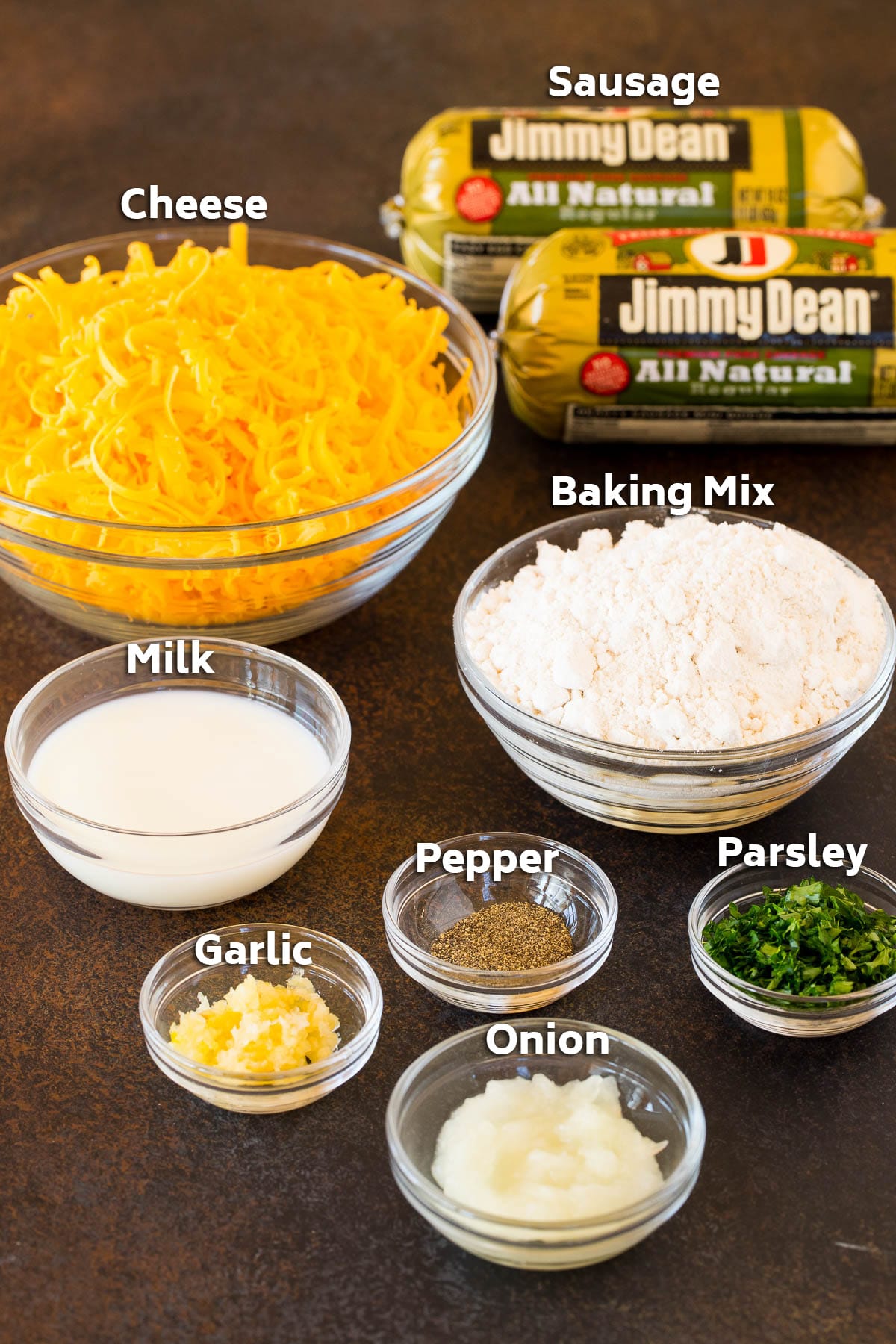 Bowls of ingredients including sausage, cheese, bisquick and seasonings.