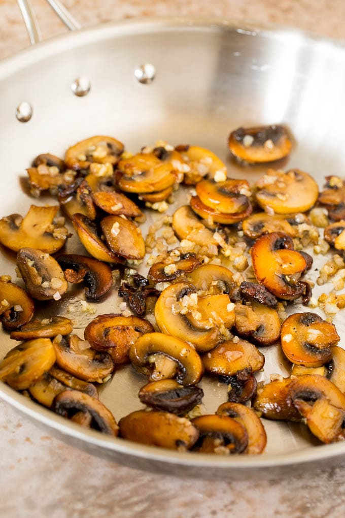 This Steak Diane recipe is beef tenderloin medallions that are seared and coated in a savory mushroom sauce. Sauteed mushrooms and shallots in a skillet.