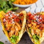 Chicken tinga tacos with lettuce and pico de gallo.