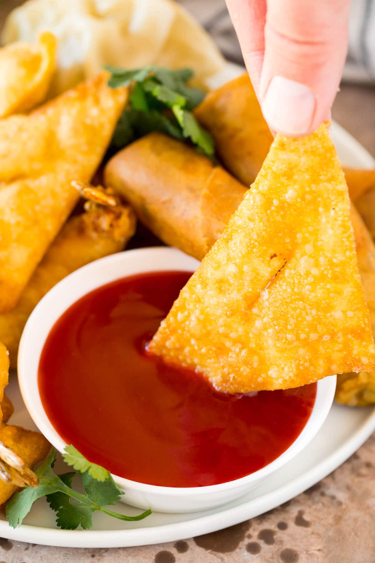 This sweet and sour sauce is a homemade version of the classic Asian sauce that takes just minutes to make and uses common pantry ingredients. A wonton being dipped into a bowl of sweet and sour sauce.